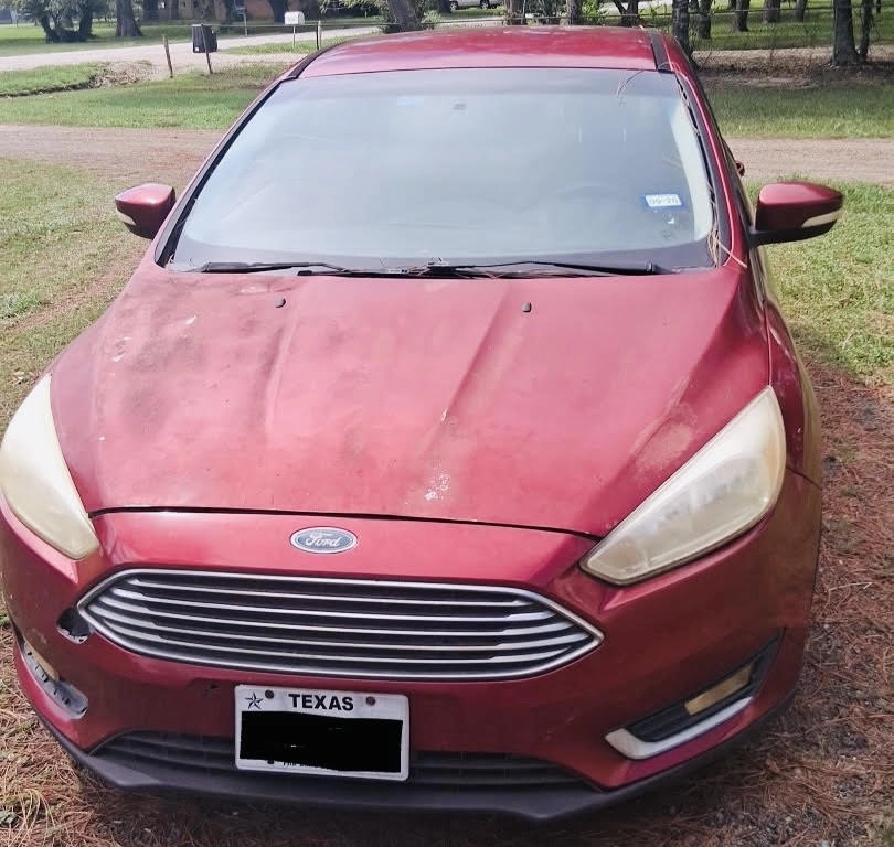 Red Ford Focus parked outdoors in La Marque, Texas.