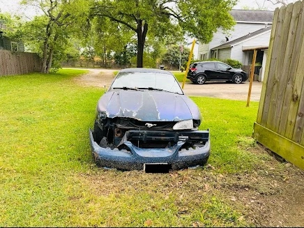 Damaged car in Houston yard ready for junk car removal with free towing
